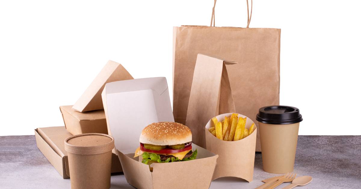 Food packaging perfectly suited for delivery, made of brown paper and cardboard materials and containing a burger and french fries.