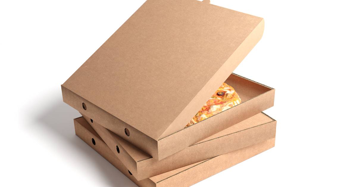 A stack of three cardboard pizza boxes on a plain white surface—the top box is open to reveal a pizza inside, topped with olives and cheese.