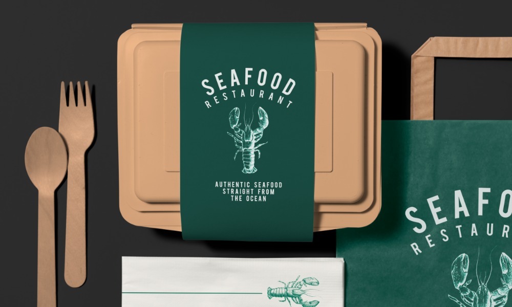 Branded seafood restaurant takeout container with paper utensils and packaging materials, showcasing secure food packaging.