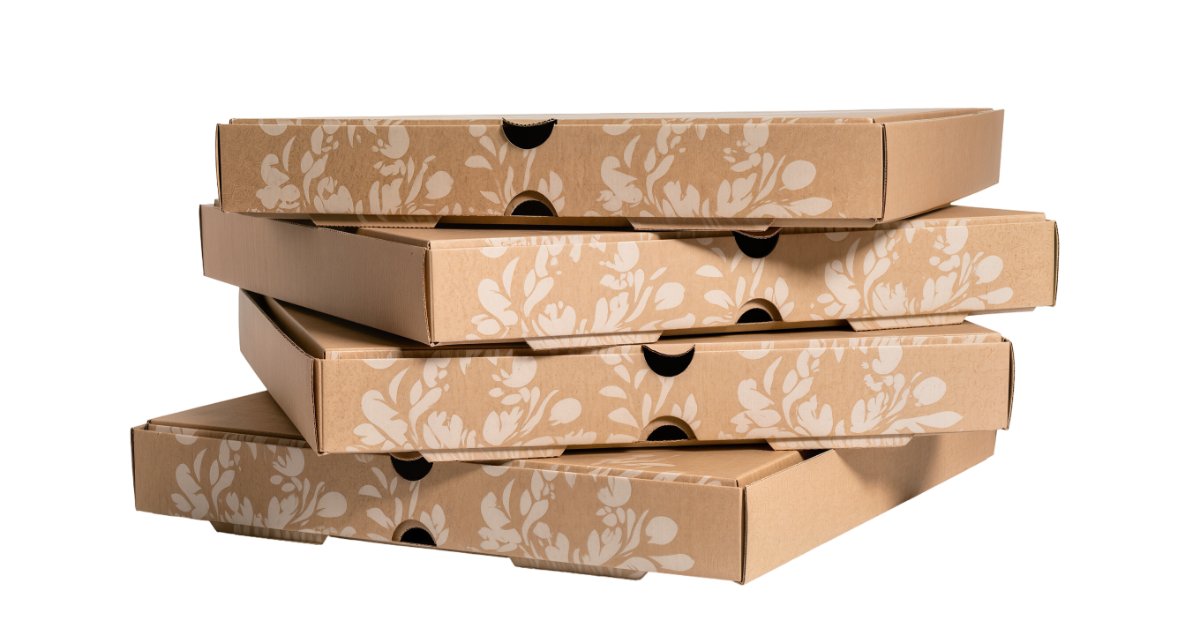 What To Expect When Ordering Custom Catering Boxes A side view of a stack of four cardboard pizza boxes with decorative flower designs against a white background.