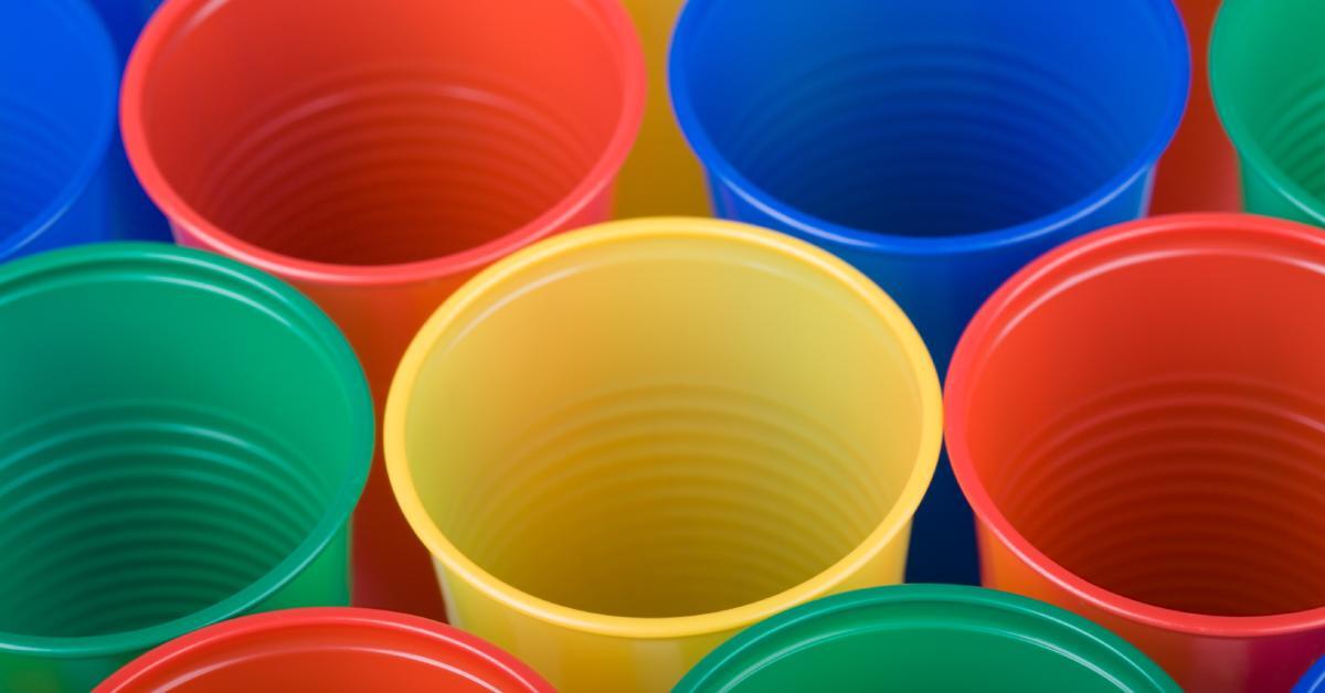 An array of PET plastic cups with their tops facing up in a variety of colors, including red, blue, yellow, and green.