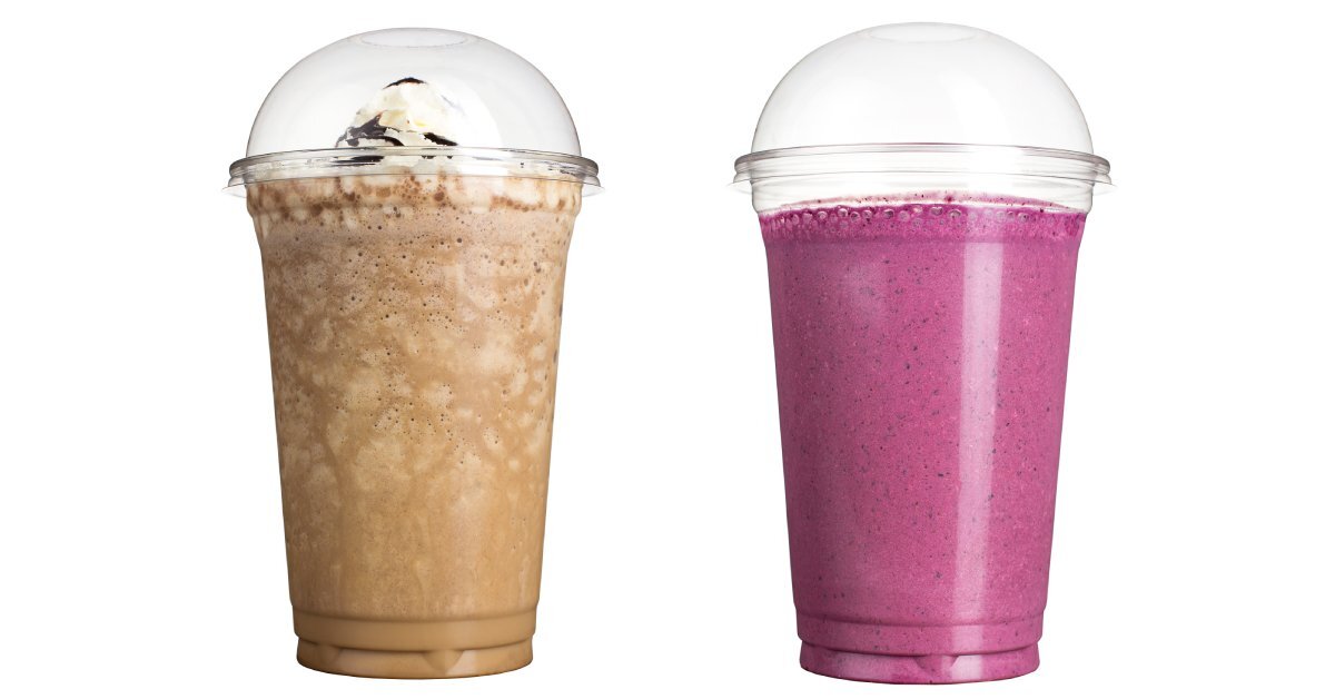 Two smoothies in plastic cups with domed lids sit in front of a white background. One is chocolate and the other is berry.